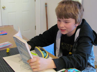 boy in hoodie reading